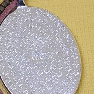 Kenneth Cole Silver Floral Pendant with Pink Cord